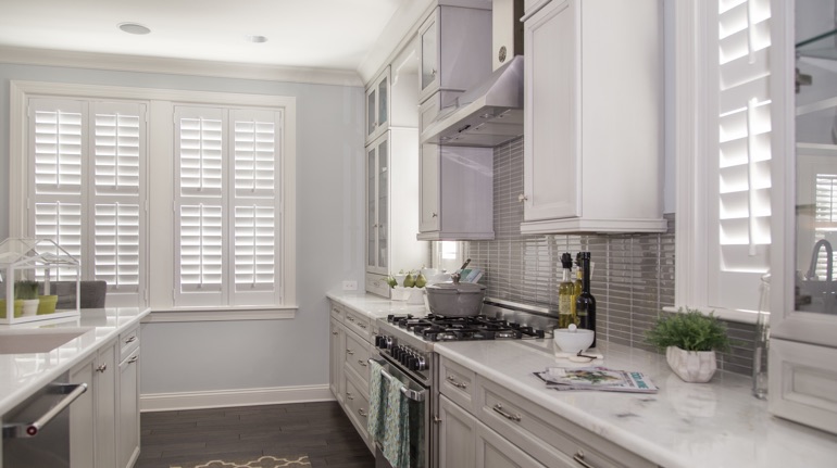 White shutters in Las Vegas kitchen with marble counter.